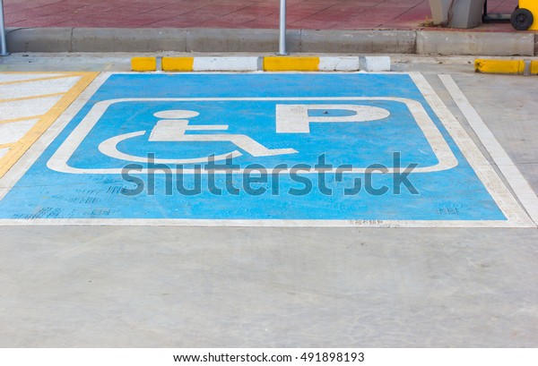Disabled
parking sign in filling station,
Thailand.