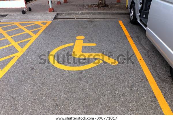 Disabled parking sign.  Parking for disabled,\
handicapped citizens. Empty parking\
lot