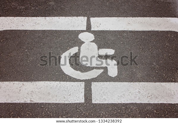 Disabled Parking sign on\
asphalt