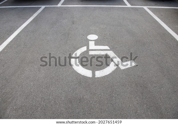 disabled parking sign on
dark asphalt