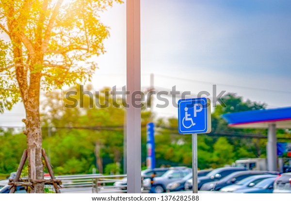 Disabled people parking car sign on pump oil fuel\
service 