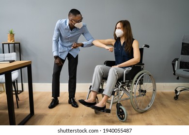 Disabled People In Wheelchair Elbow Bump In Office