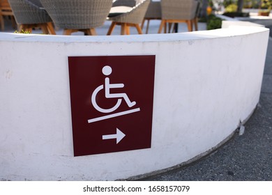 Disabled People Wheelchair Ramp Icon Sign On The Pier Near Cafe

