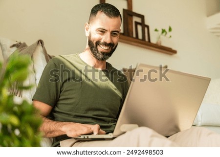disabled person smiling and using laptop