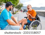 A disabled person in a wheelchair with a friend on summer vacation having fun laughing a lot