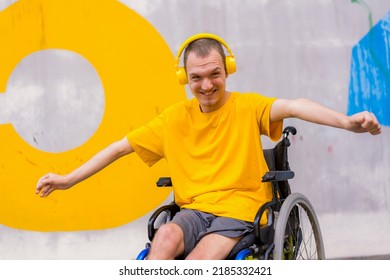 Disabled person in a wheelchair listening to music with headphones, dancing and smiling - Powered by Shutterstock