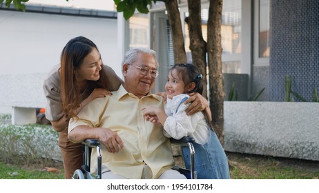 Disabled Senior Grandpa On Wheelchair With Grandchild And Mother In Park, Happy Asian Three Generation Family Having Fun Together Outdoors Backyard, Grandpa And Little Child Smiling And Laughed