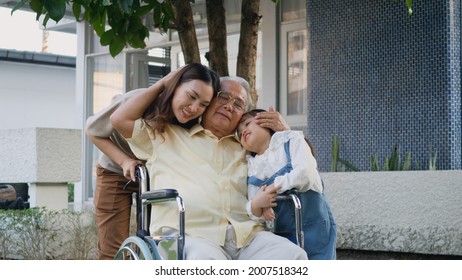 Disabled Senior Grandpa On Wheelchair With Grandchild And Mother In Park, Happy Asian Three Generation Family Having Fun Together Outdoors Backyard, Grandpa And Little Child Smiling And Laughed