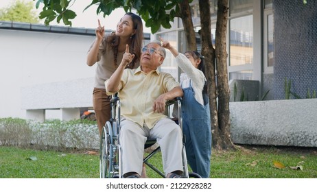 Disabled Senior Grandpa On Wheelchair With Grandchild And Mother In Park, Happy Asian Three Generation Family Having Fun Together Outdoors Backyard, Grandpa And Little Child Smiling And Laughed