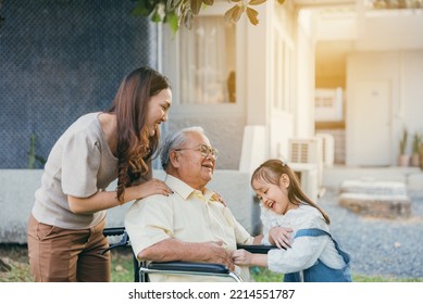 Disabled Senior Grandpa On Wheelchair With Grandchild And Mother In Park, Happy Asian Multi Generation Family Having Fun Together Outdoors Backyard, Grandpa Elderly And Little Child Smiling And Laugh.