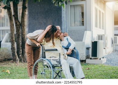 Disabled Senior Grandpa On Wheelchair With Grandchild And Mother In Park, Happy Asian Multi Generation Family Having Fun Together Outdoors Backyard, Grandpa Elderly And Little Child Smiling And Laugh.