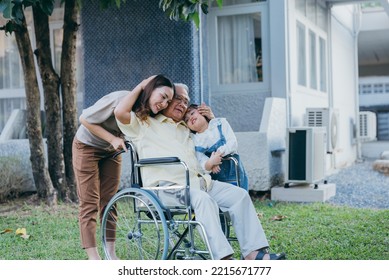 Disabled Senior Grandpa On Wheelchair With Grandchild And Mother In Park, Happy Asian Multi Generation Family Having Fun Together Outdoors Backyard, Grandpa Elderly And Little Child Smiling And Laugh.