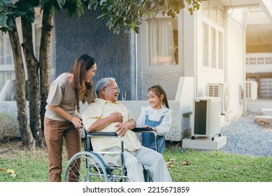 Disabled Senior Grandpa On Wheelchair With Grandchild And Mother In Park, Happy Asian Multi Generation Family Having Fun Together Outdoors Backyard, Grandpa Elderly And Little Child Smiling And Laugh.