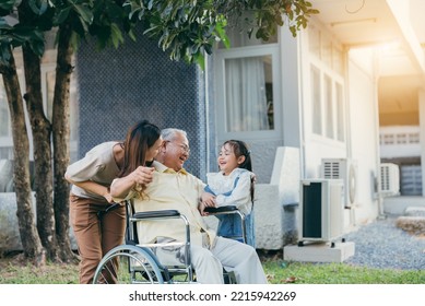 Disabled Senior Grandpa On Wheelchair With Grandchild And Mother In Park, Happy Asian Multi Generation Family Having Fun Together Outdoors Backyard, Grandpa Elderly And Little Child Smiling And Laugh.