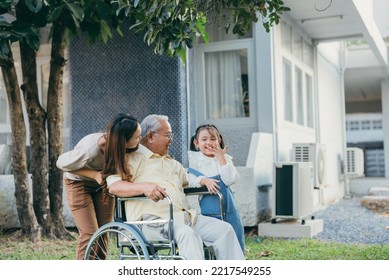 Disabled Senior Grandpa On Wheelchair With Grandchild And Mother In Park, Happy Asian Multi Generation Family Having Fun Together Outdoors Backyard, Grandpa Elderly And Little Child Smiling And Laugh.