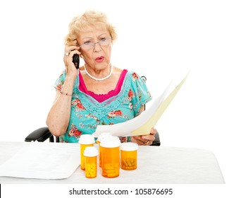 Disabled Senior Woman Shocked By The Cost Of Medical Care And Prescription Medicine.  White Background.