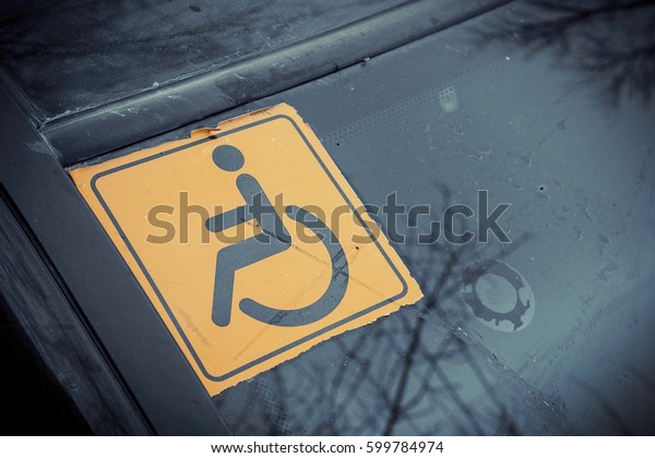 Disabled sign on the\
car glass. Macro shot.