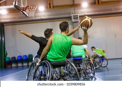 Disabled Sport Men In Action While Playing Indoor Basketball At A Basketball Court