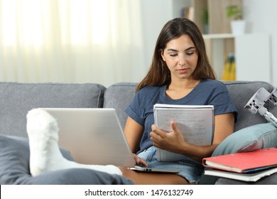 Disabled student studying hard learning sitting on a couch in the living room at home