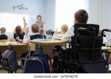 A disabled student in a wheelchair in primary school. Socialization of the individual in society.