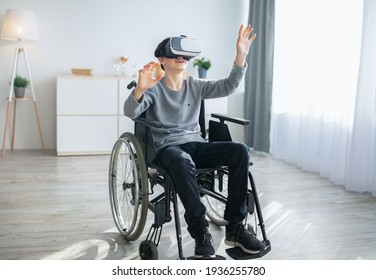 Disabled teen boy in wheelchair exploring augmented reality in VR headset. Home entertainment with modern technologies - Powered by Shutterstock