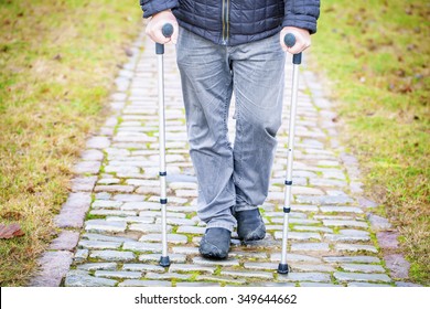 Disabled  Veteran On Crutches At Cemetery