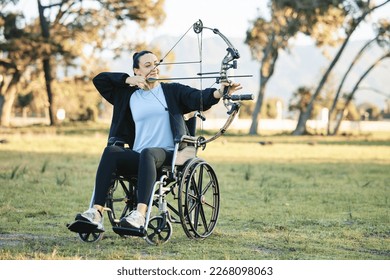 Disabled woman, outdoor archery in wheelchair and challenge with active sports lifestyle in Canada. Person with disability in a park, fitness activity to exercise arms and aim arrow for hobby