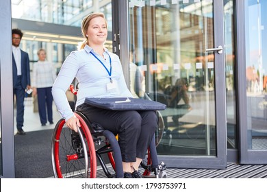 Disabled Woman In A Wheelchair In Front Of The Office For Inclusion And After Work Concept