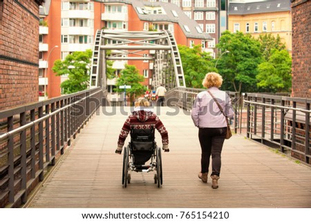 disabled woman wheelchair woman and woman go through the bridge Stock photo © 