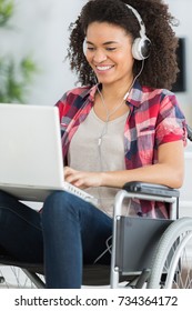 Disabled Woman In Wheelchair With Laptop