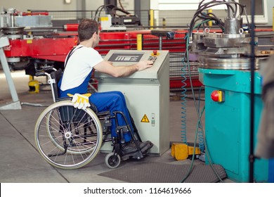 Disabled Worker In Wheelchair In Factory On The Machine