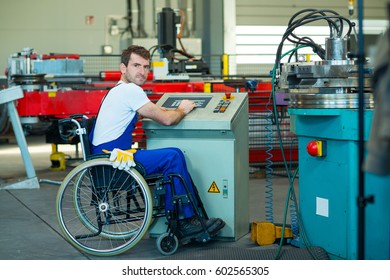 Disabled Worker In Wheelchair In Factory On The Machine