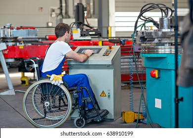 Disabled Worker In Wheelchair In Factory On The Machine