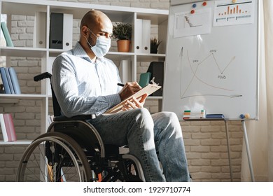 Disabled young man making presentation in office wearing medical mask - Powered by Shutterstock