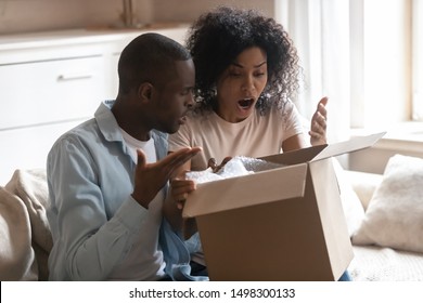 Disappointed Biracial Husband And Wife Unpack Cardboard Box Get Wrong Order, Frustrated African American Client Couple Open Unbox Delivery Package, Feel Confused Receive Bad Quality, Damaged Product