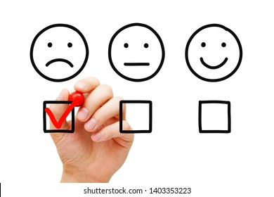 Disappointed client leaving negative evaluation with red marker check mark on customer feedback survey. Unhappy drawn face concept.