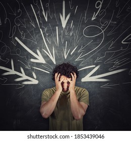 Disappointed guy covers face with his hands, looking down introverted and depressed, being under pressure as multiple arrows points tension negativity to his head. Person suffering emotional breakdown - Shutterstock ID 1853439046
