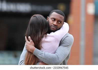 Disappointed Man Hugging A Woman In The Street