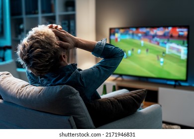 Disappointed man watching his football team losing the match on TV - Powered by Shutterstock