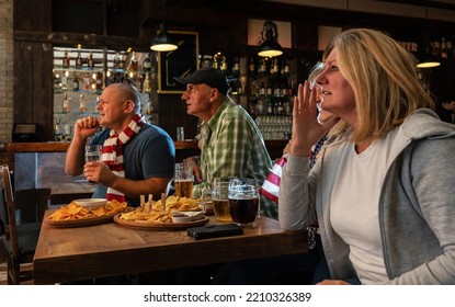 Disappointed Mature Football And Soccer Fans Drinking Beer At The Pub And Watching A Match. The Player Misses A Chance To Score.	
