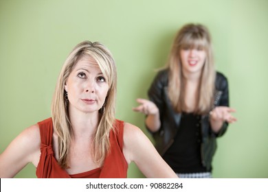 Disappointed Mom With Frustrated Daughter In Background