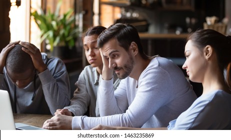 Disappointed multiracial millennial friends gather in cafe feel sad stressed after sports team lose game, distressed diverse young people frustrated by match bad result, lost hope and failure concept - Powered by Shutterstock