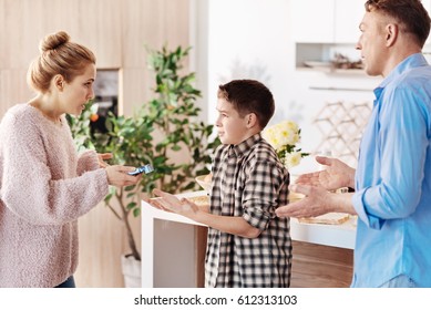 Disappointed Parents Scolding Their Son For Smoking