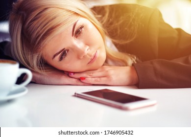 Disappointed Sad Woman Looking At Phone And Waiting Message Or Call.