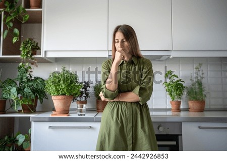Disappointed serious worried woman pondering at home on kitchen. Upset frustrated thoughtful blonde female have problems, depression, desperation, hopelessness, frustration negative emotions in stress