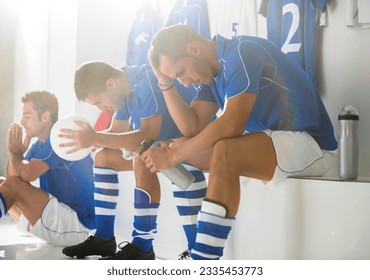 Disappointed soccer players sitting in locker room - Powered by Shutterstock