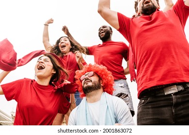 Disappointed Supporter Football Fan With Rival Spectators Celebrating Victory At Stadium - Championship And Sports Concept