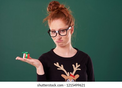 Disappointed Woman Holding A Christmas Present