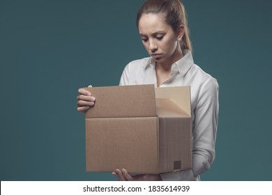 Disappointed Woman Looking Into A Cardboard Box, She Has Received The Wrong Delivery