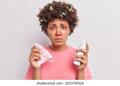 Disappointed Young Afro American Woman Uses Nasal Aerosol Suffers From Allergic Rhinitis Has Red Swollen Eyes Looks Unhappily At Camera Dressed In Casual T Shirt Isolated Over White Background